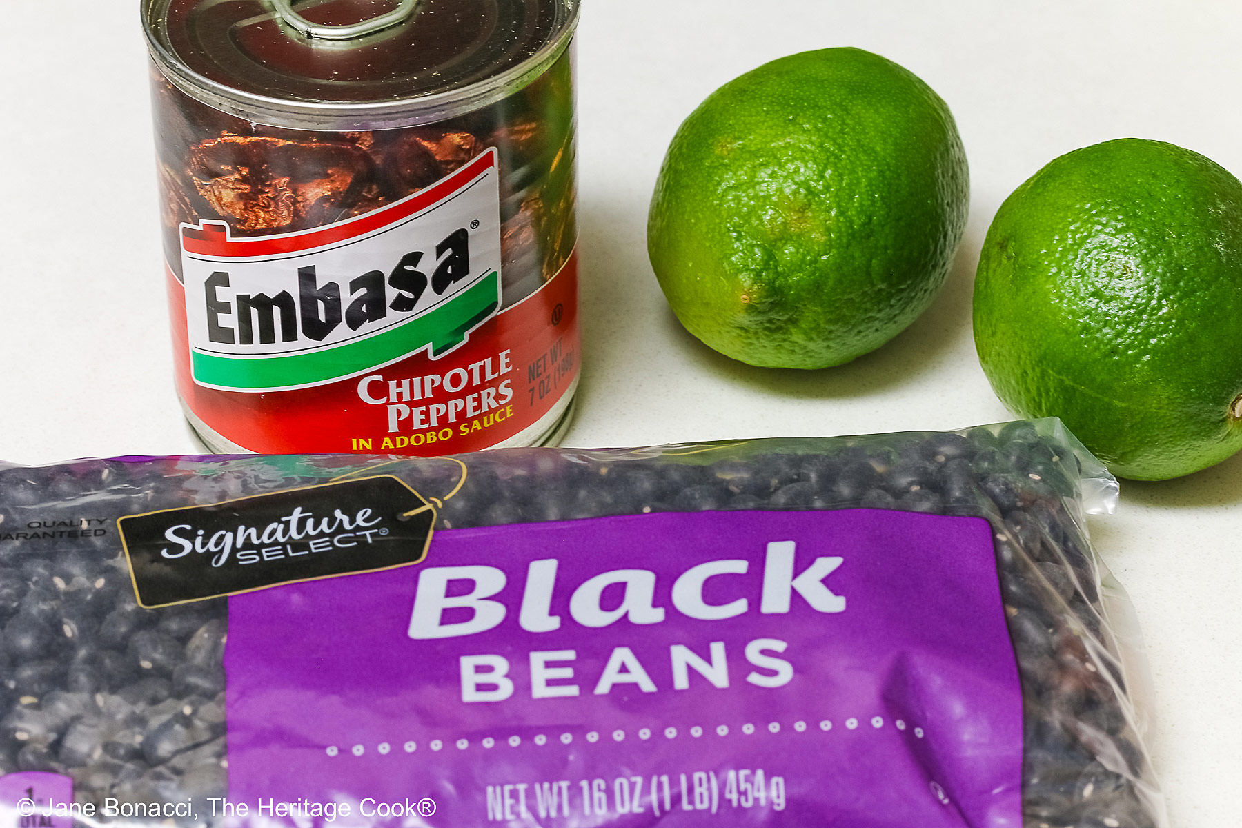 Ingredients, black beans, limes, and chipotles en adobo. 