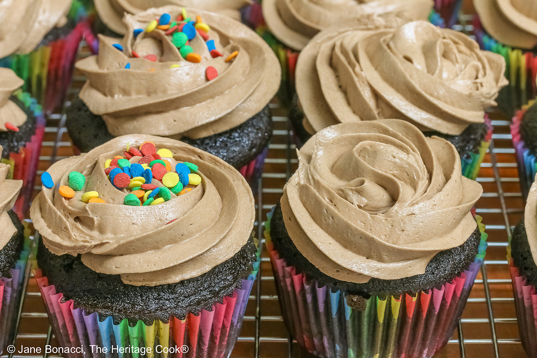 Some cupcakes with sprinkles, some plain.