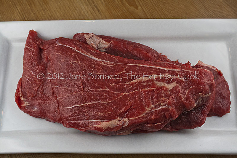 Raw flat iron steak, showing the grain and marbling