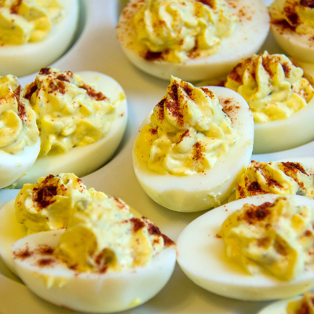 Hard boiled eggs sliced in half and filled with the yolk mixture and sprinkled with paprika; Old Fashioned Deviled Eggs and Perfectly Cooked Eggs; 2023 Jane Bonacci, The Heritage Cook.