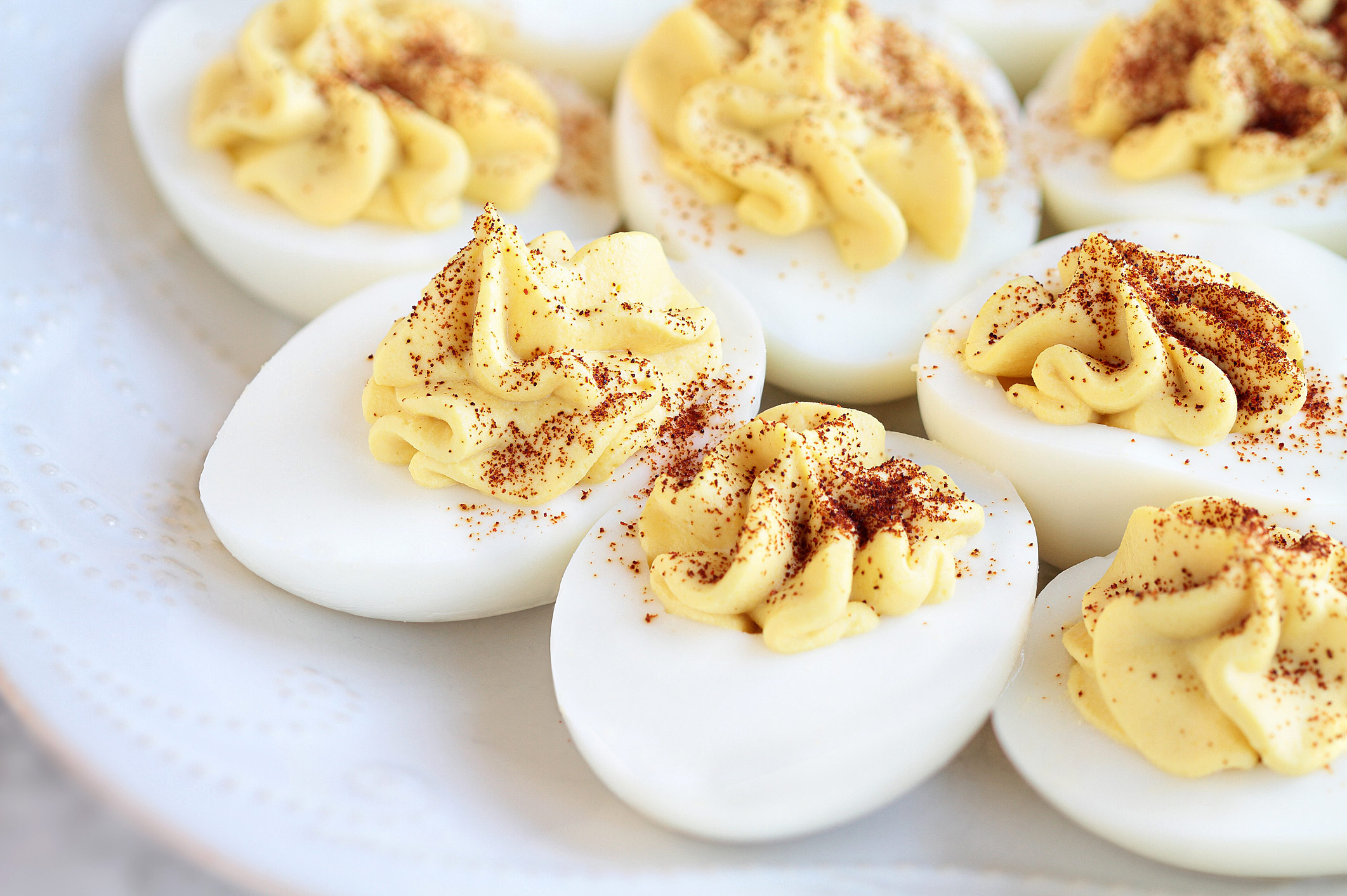 Hard boiled eggs sliced in half and filled with the yolk mixture and sprinkled with paprika; Old Fashioned Deviled Eggs and Perfectly Cooked Eggs; 2023 Jane Bonacci, The Heritage Cook.