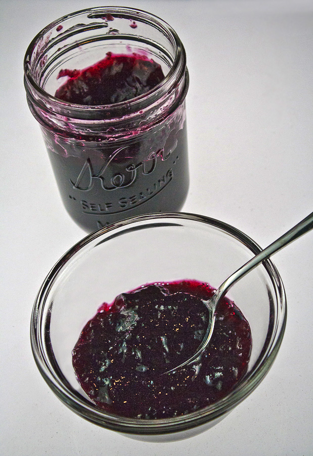 Homemade Blueberry Jam from The Heritage Cook; bowl with fresh blueberry jam and spoon