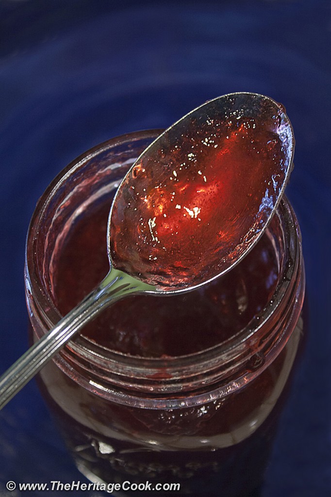 Jar of homemade plum jam with spoon