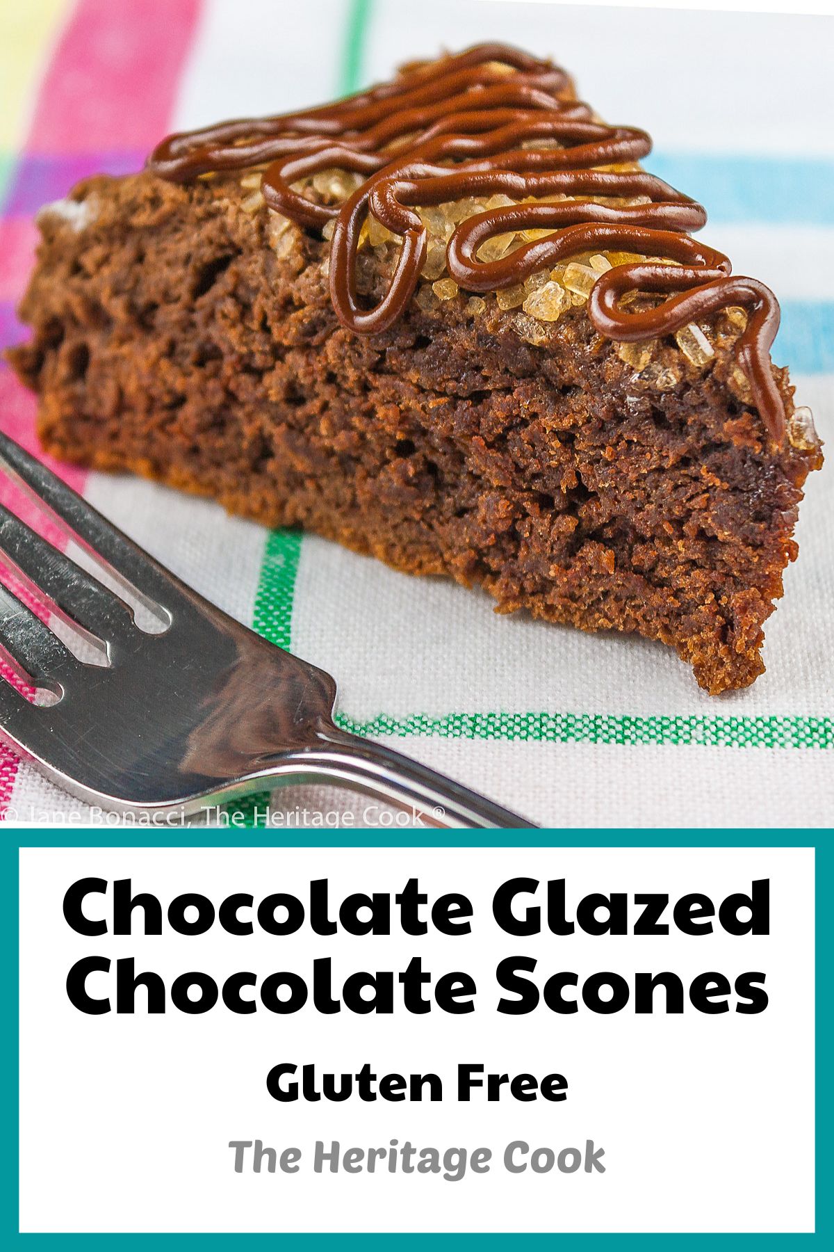 Scones cut into wedges, topped with coarse sugar and chocolate glaze on colorful cloth; Chocolate Glazed Chocolate Scones © 2023 Jane Bonacci, The Heritage Cook. 