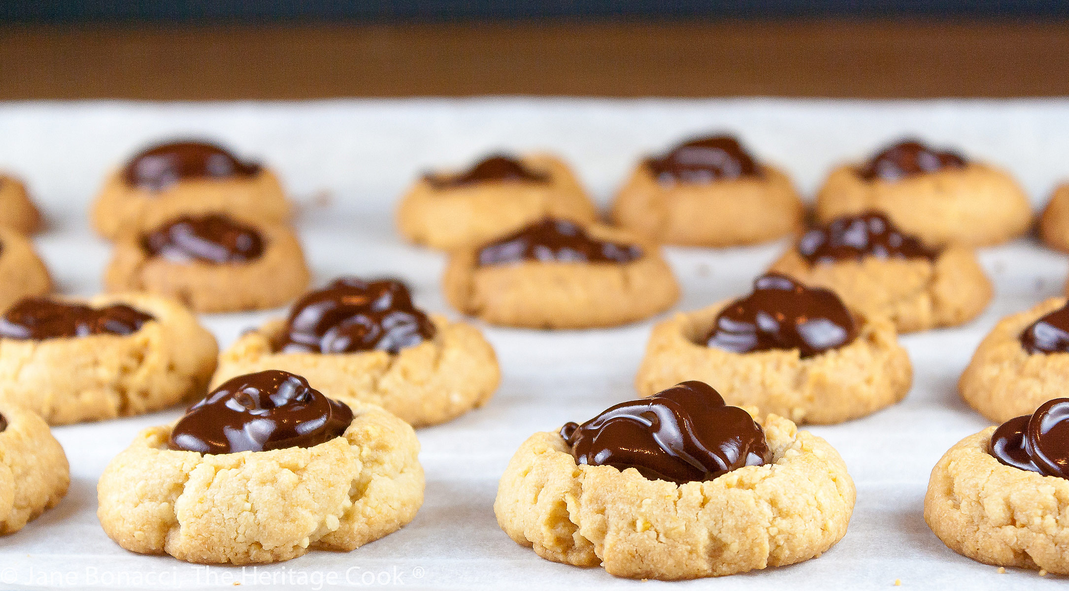 Cookies filled with ganache on parchment paper - a field of cookies! 