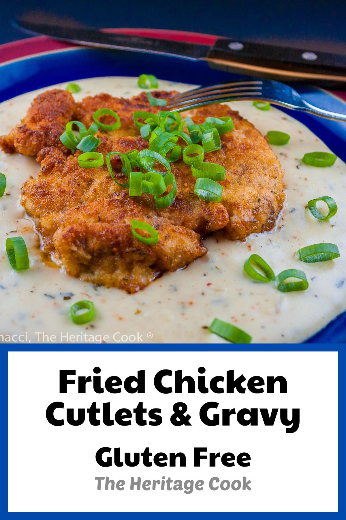 Golden fried chicken breasts resting on cream gravy and topped with green onions on blue and red plate; Fried Chicken Cutlets with Cream Gravy © 2023 Jane Bonacci, The Heritage Cook. 