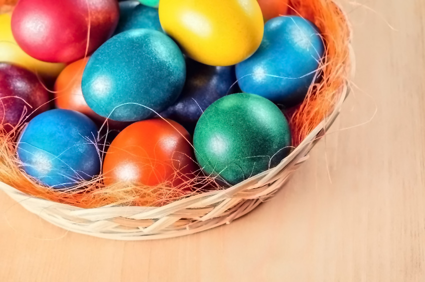 Basket of beautiful, vibrantly colored Easter Eggs