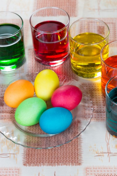 Coloring eggs in bright colors for Easter holiday