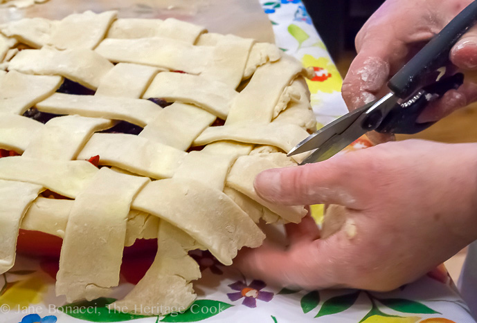 Kate's capable hands trimming the edge of pie dough