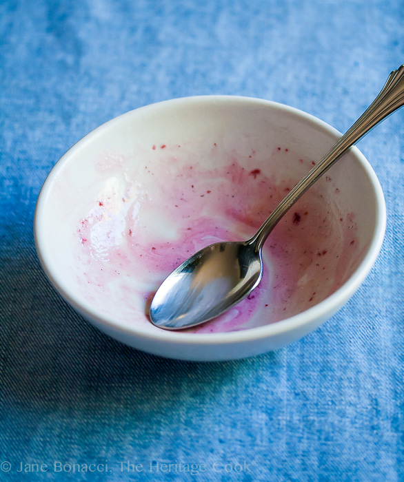 Empty bowl with remnants of the parfait and a spoon