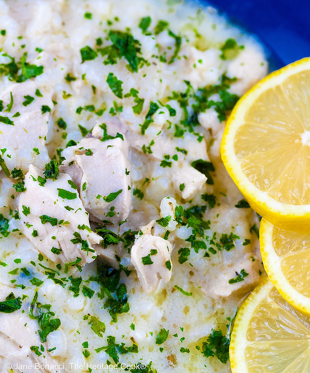 Tight close up of the bowl of soup with a ton of chicken pieces.