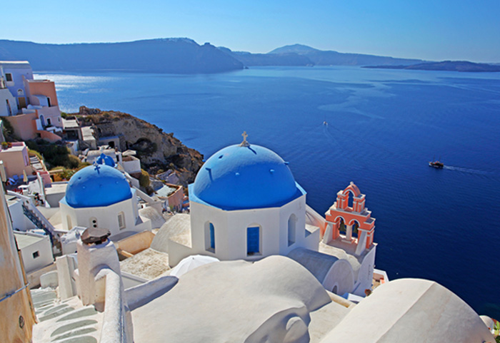 Photo of Santorini, Greece with white buildings and the deepest blue ocean