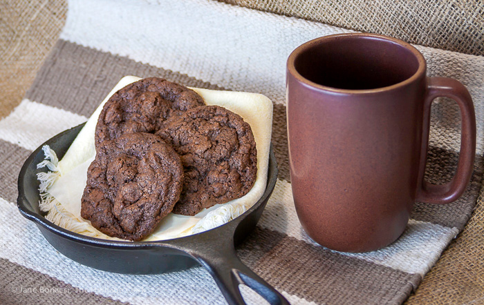 Gluten-Free Bacon Double Chocolate Chip Cookies in cast iron skillet on rustic setting
