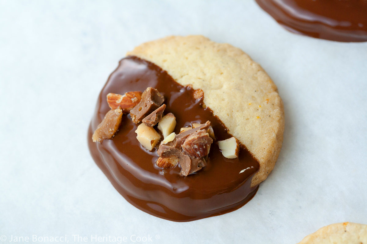 single freshly dipped cookie; Toffee Topped Chocolate Dipped Butter Cookies (Gluten-Free); 2015 Jane Bonacci, The Heritage Cook