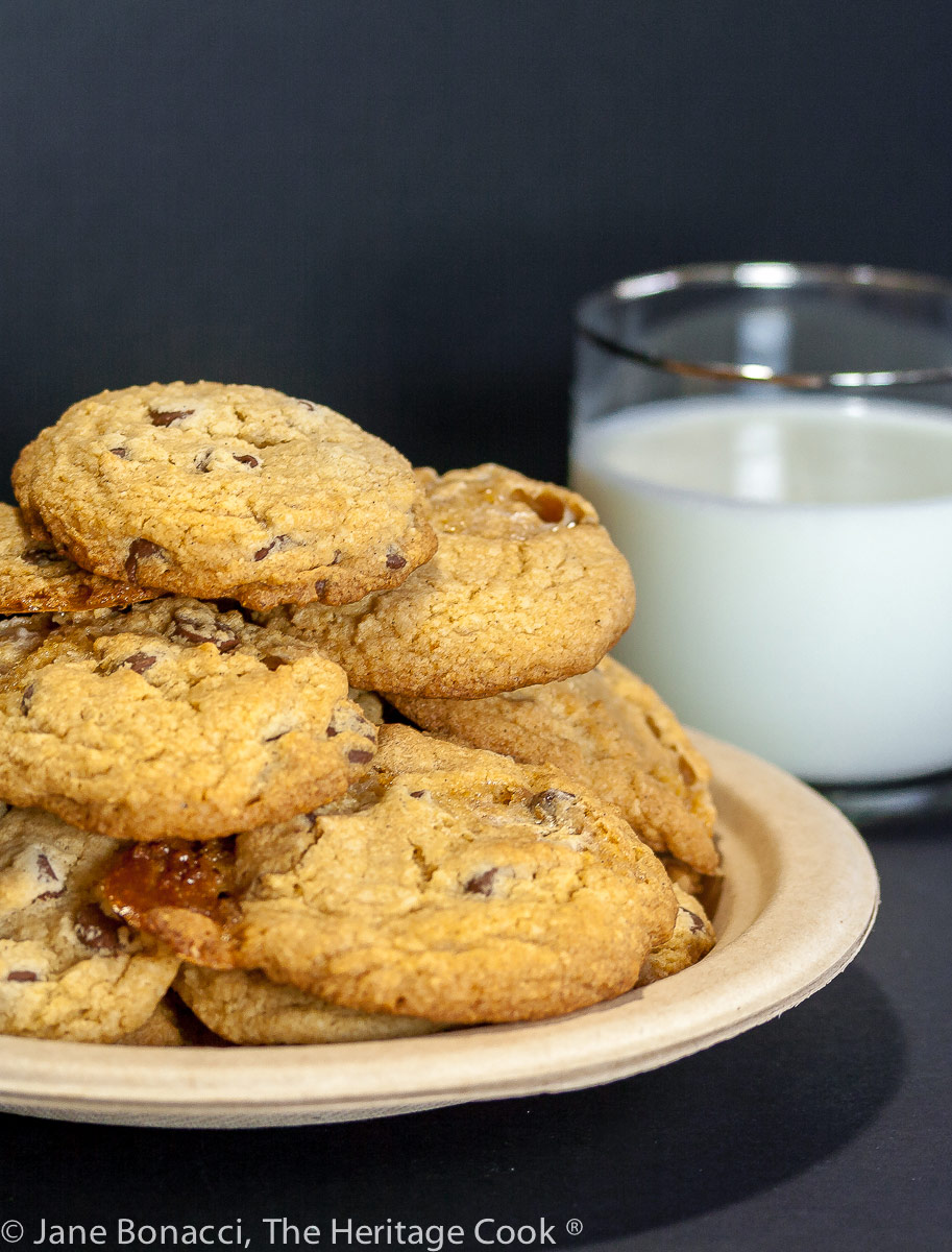 Pile of cookies on a plate with a glass of milk in the background; S’mores Chocolate Chip Cookies (Gluten Free) © 2022 Jane Bonacci, The Heritage Cook.