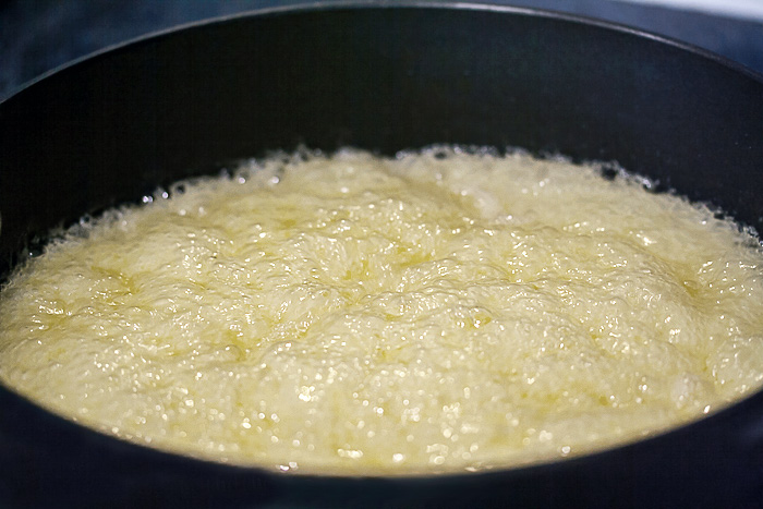 Pan of boiling sugar on its way to becoming caramel