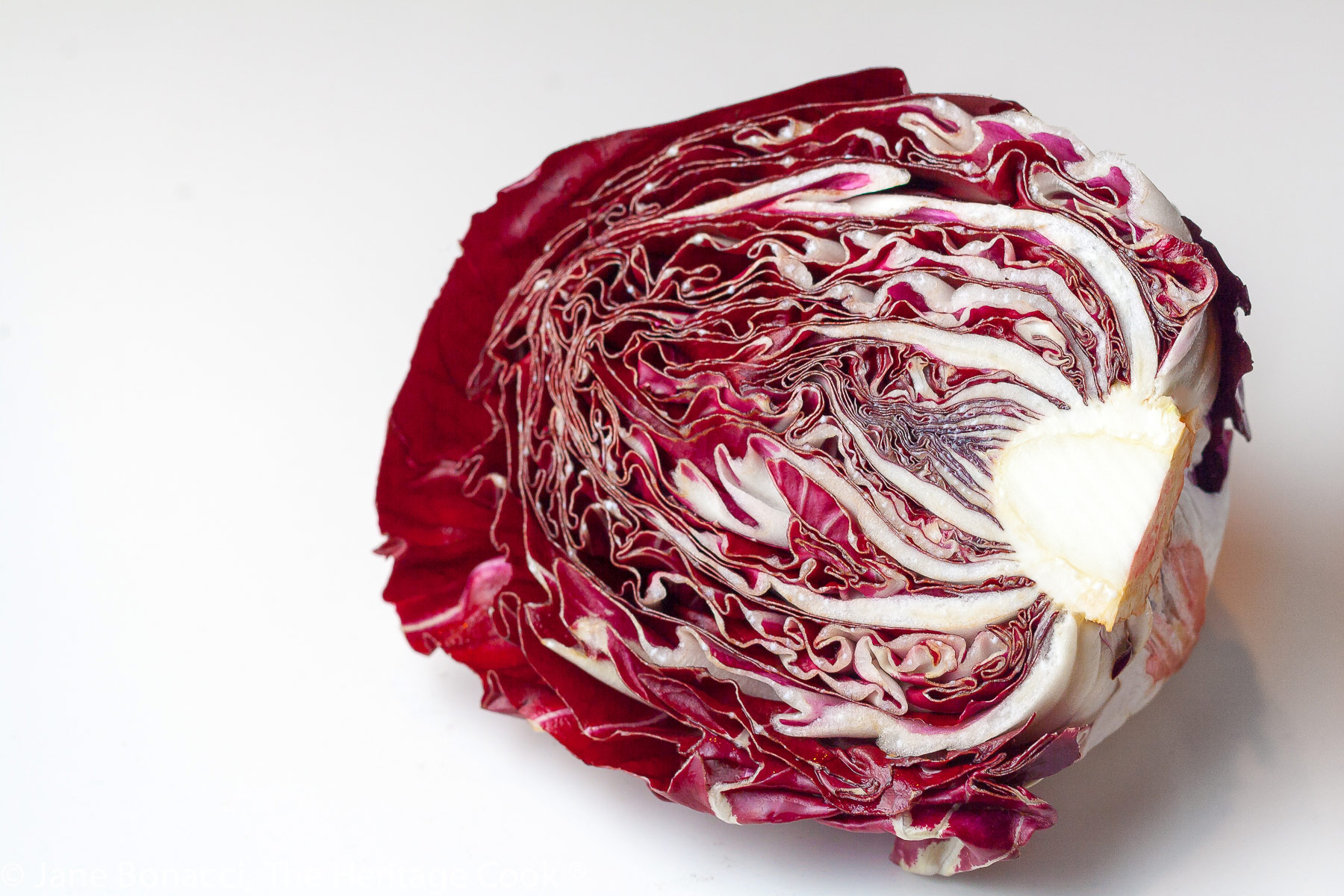 red cabbage cut in half showing the internal layers. 