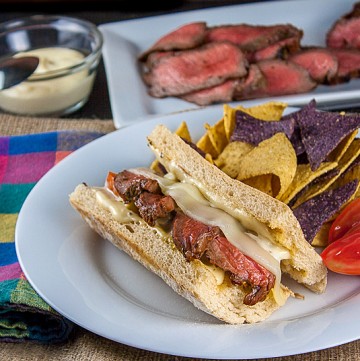 BBQ Steak covered with melted cheese and more in these amazing sandwiches perfect for tailgating or any party; Cheesy Grilled Steak Sandwiches; 2015 Jane Bonacci, The Heritage Cook
