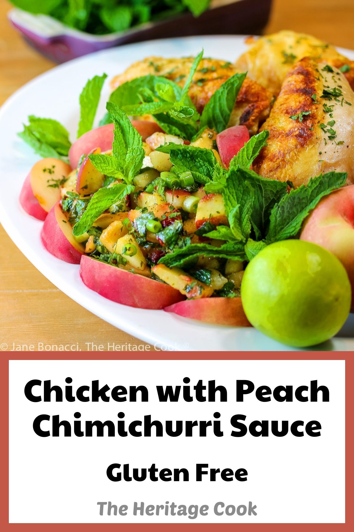 Grilled chicken breasts on a white platter, accompanied by a peach and herb chimichurri sauce, surrounded by sliced peaches and mint sprigs © 2023 Jane Bonacci, The Heritage Cook. 
