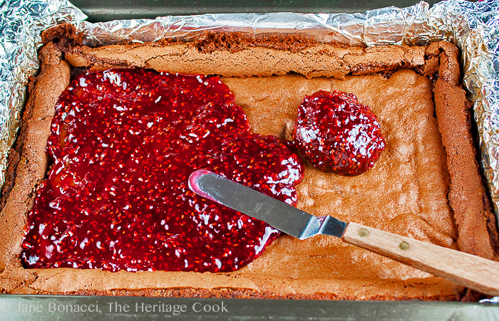 Spreading raspberry jam on top of brownies; Raspberry Chocolate Brownies; 2015 Jane Bonacci, The Heritage Cook