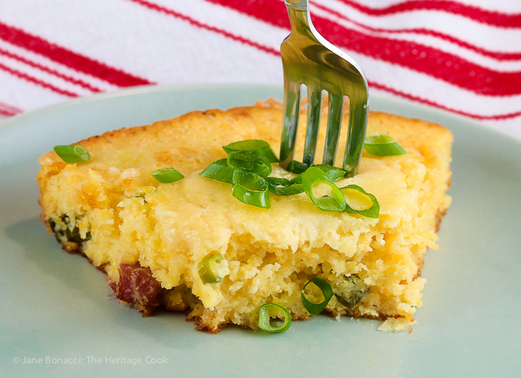 Fork stuck in slice of Cheesy Skillet Cornbread with Cheddar and Tasso Ham © 2017 Jane Bonacci, The Heritage Cook