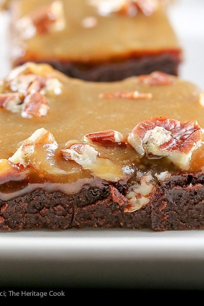 Close up of edge of caramel covered brownie; Dark Chocolate Brownies with Pecans and Caramel © 2017 Jane Bonacci, The Heritage Cook