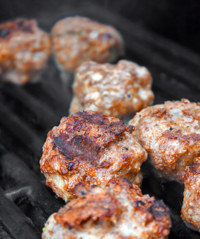 Meatballs cooking on the BBQ; Grilled Meatball Hoagie Sandwiches with Spicy Tomato Sauce and Melted Cheese © 2018 Jane Bonacci, The Heritage Cook