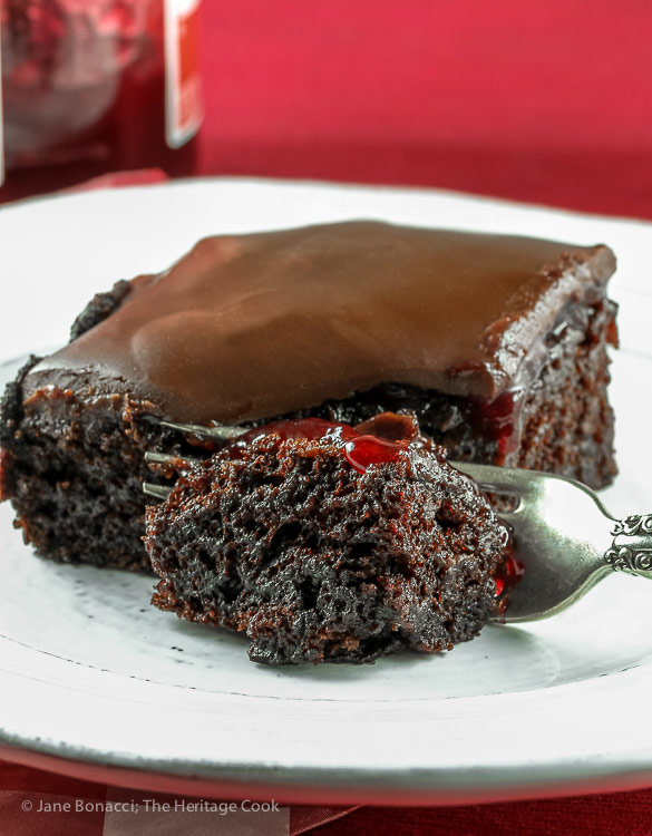 Bite on a fork in front of slice of cake; Chocolate Raspberry Sheet Cake © 2018 Jane Bonacci, The Heritage Cook. All rights reserved. 