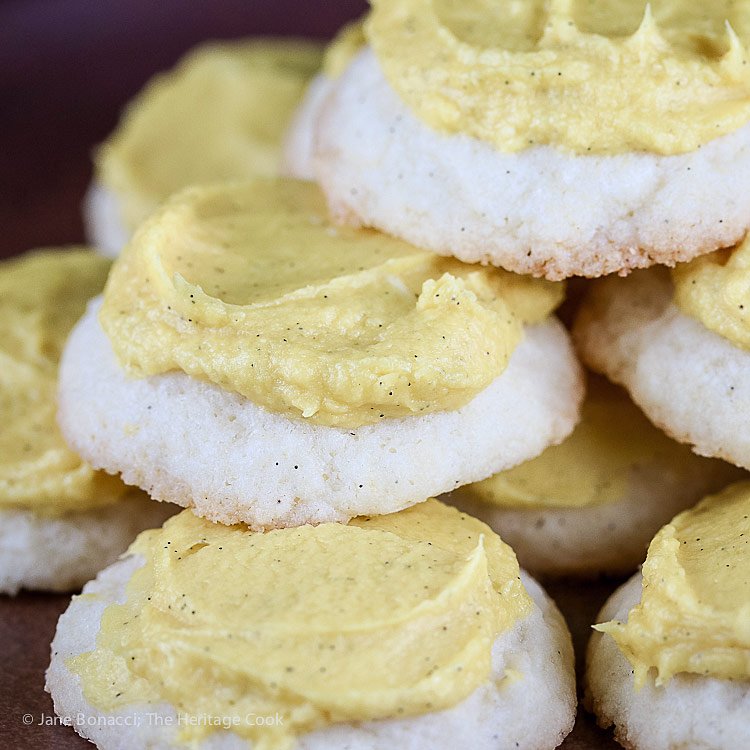 Close up of a cookie pile; Lemon White Chocolate Sugar Cookies with Lemon Buttercream Frosting © 2018 Jane Bonacci, The Heritage Cook
