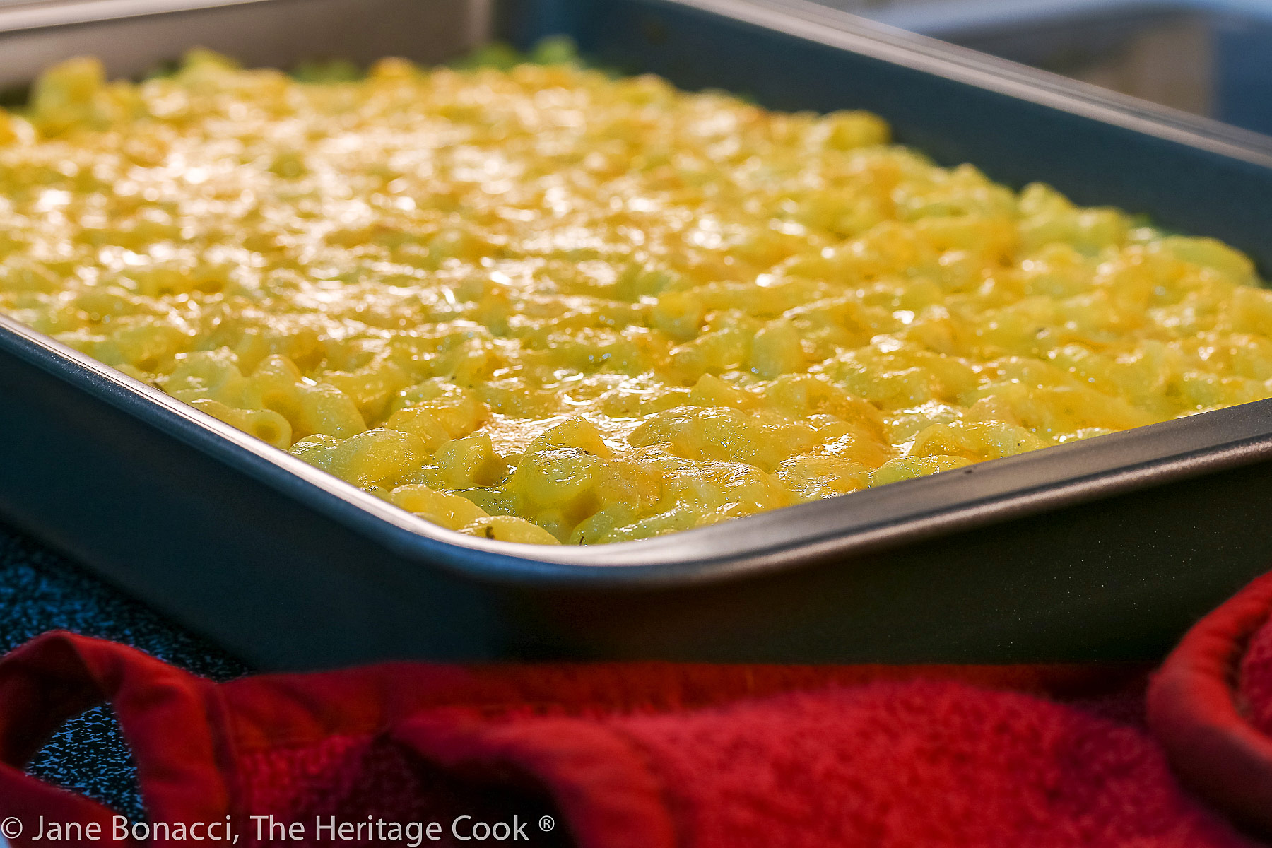Large pan of mac and cheese hot from the oven. 