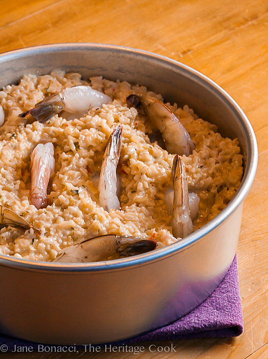 Raw shrimp tucked into the rice before baking; Baked Shrimp and Rice Casserole © 2018 Jane Bonacci, The Heritage Cook 