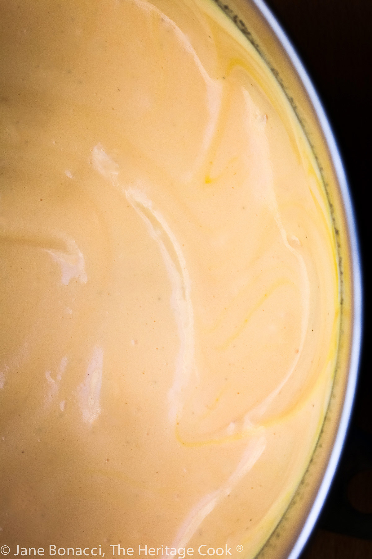 Orange mousse in a large mixing bowl. 