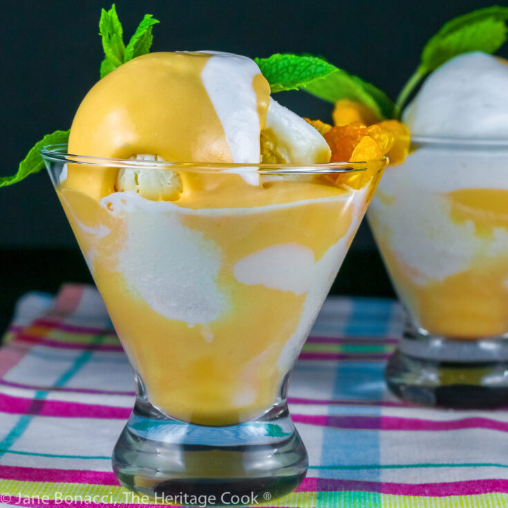 Vanilla ice cream with orange Creamsicle mousse in glass dish topped with whipped cream and a sprig of mint; on colorful cloth © 2023 Jane Bonacci, The Heritage Cook.