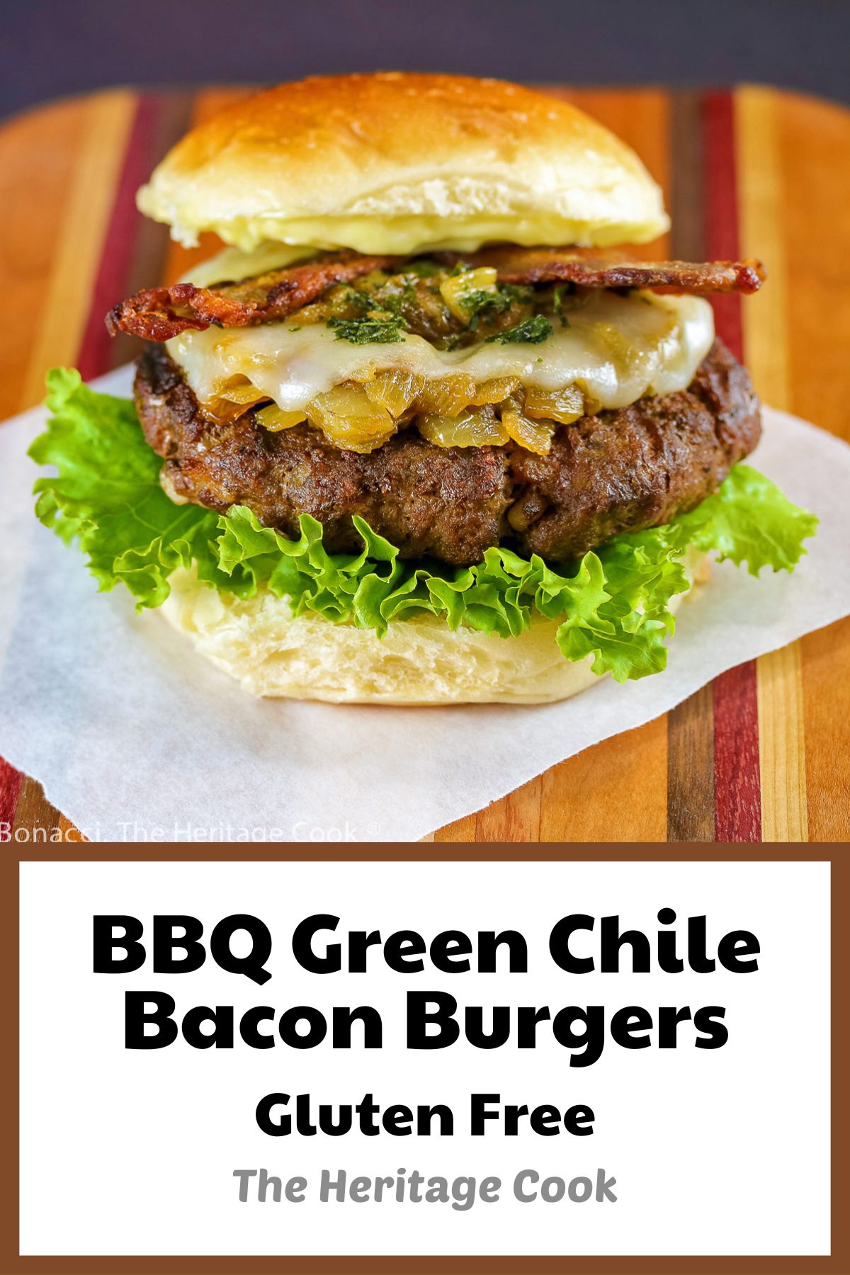 A grilled buffalo burger studded with chopped bacon fat and layered with lettuce, bacon, melted cheese, sauteed onions and Hatch green chiles; BBQ Green Chile Bacon Burgers © 2023 Jane Bonacci, The Heritage Cook. 