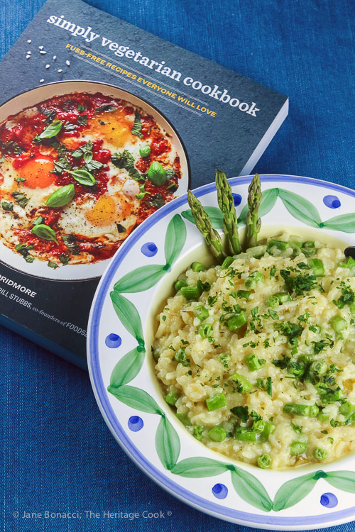 bowl of risotto with cookbook; Asparagus and Pea Risotto © 2018 Jane Bonacci, The Heritage Cook