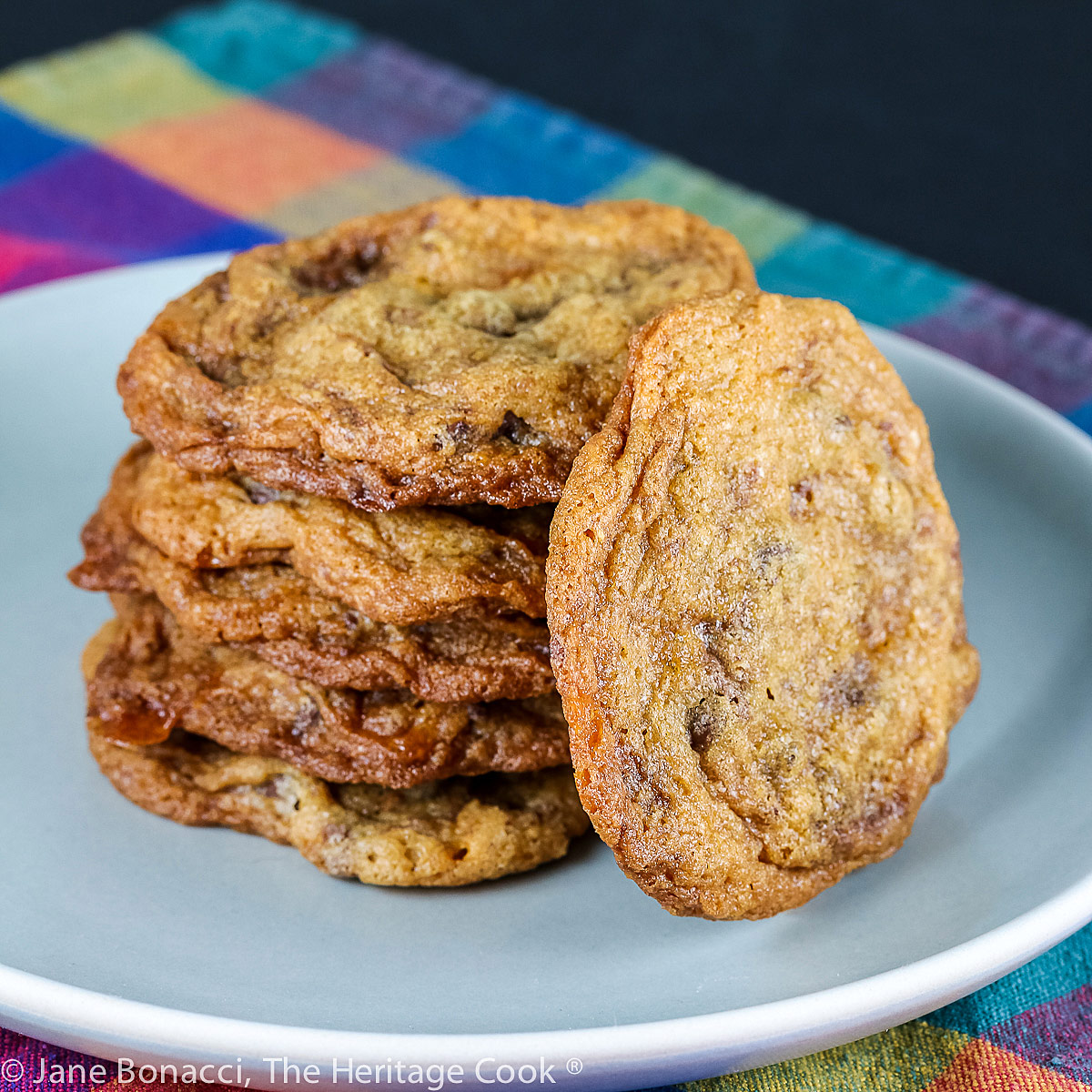 Somewhat lumpy cookies that look like chocolate chip but have Butterfinger candies in them too; Butterfinger Chocolate Chip Cookies © 2022 Jane Bonacci, The Heritage Cook.