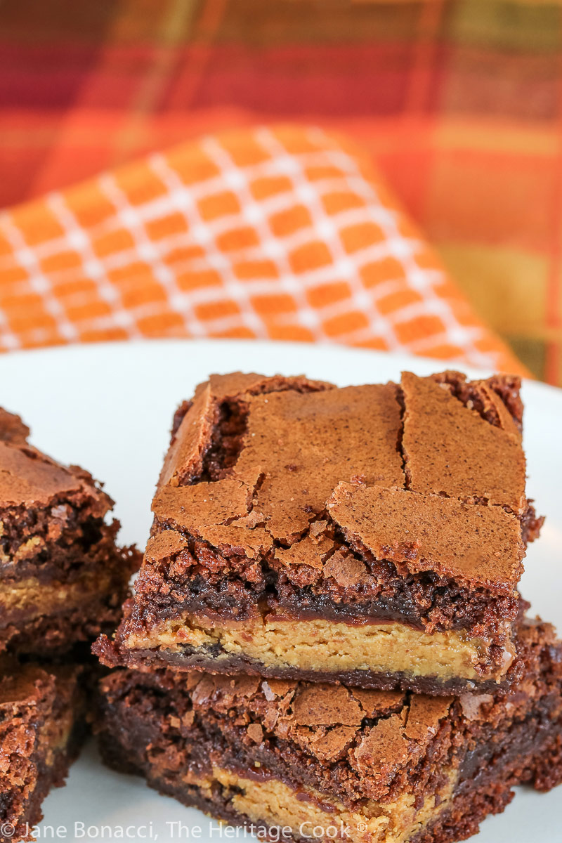 Peanut butter cups are sandwiched between two layers of brownies for these Reese's Brownies © 2022 Jane Bonacci, The Heritage Cook.