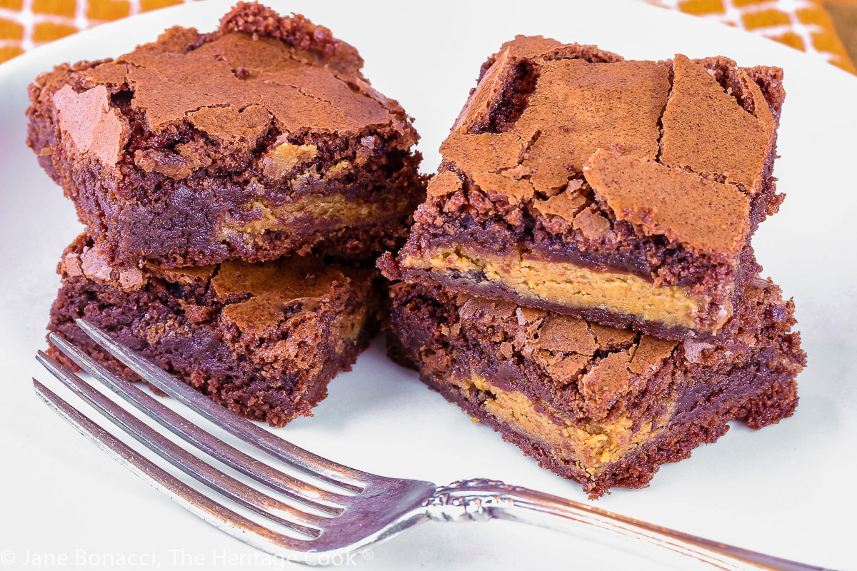 Peanut butter cups are sandwiched between two layers of brownies for these Reese's Brownies © 2022 Jane Bonacci, The Heritage Cook.
