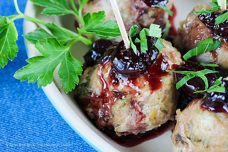 close up of meatball & sauce; Cherry Red Wine Baked Turkey Meatballs © 2019 Jane Bonacci, The Heritage Cook
