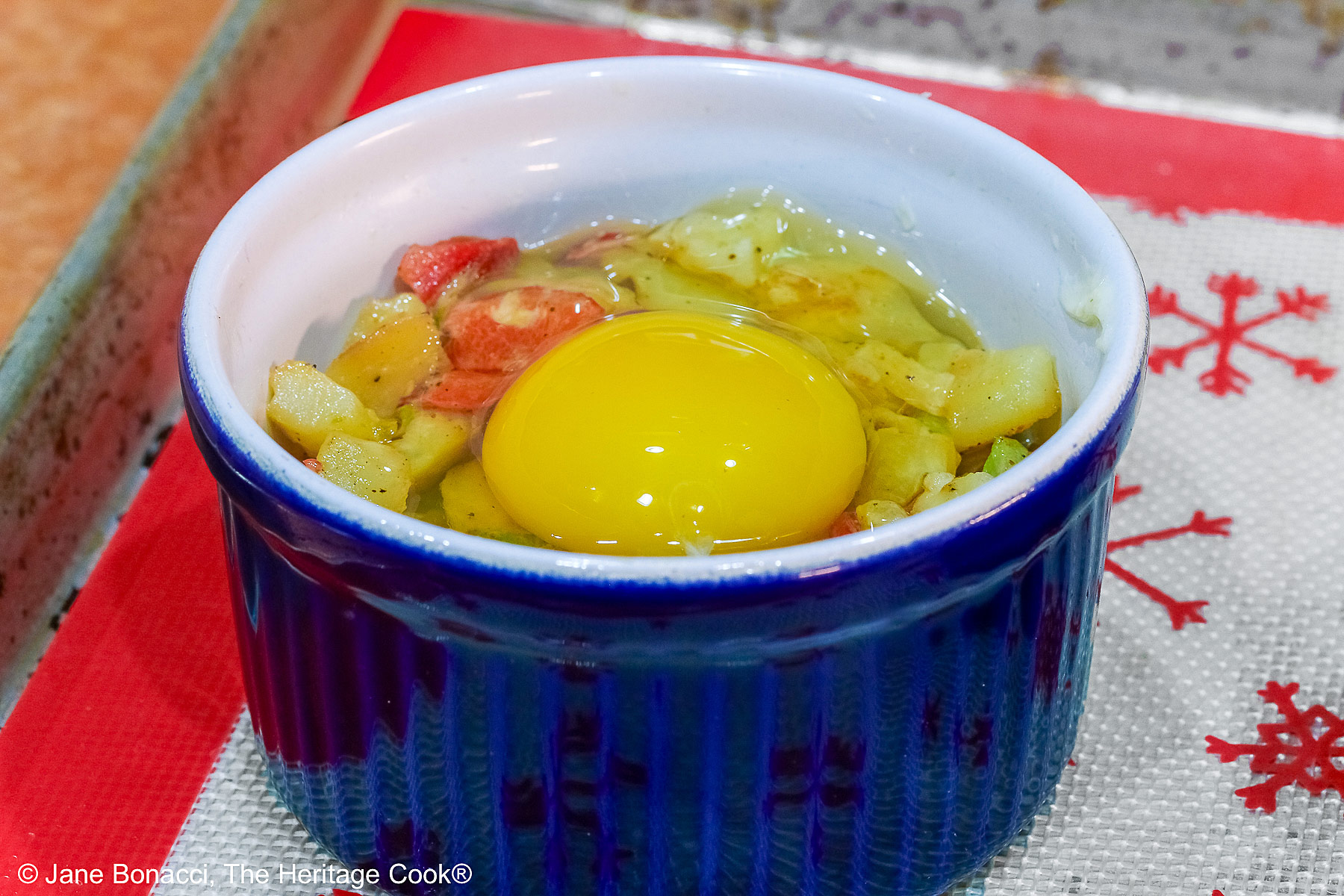 Raw egg in the potato nest ready for the oven.