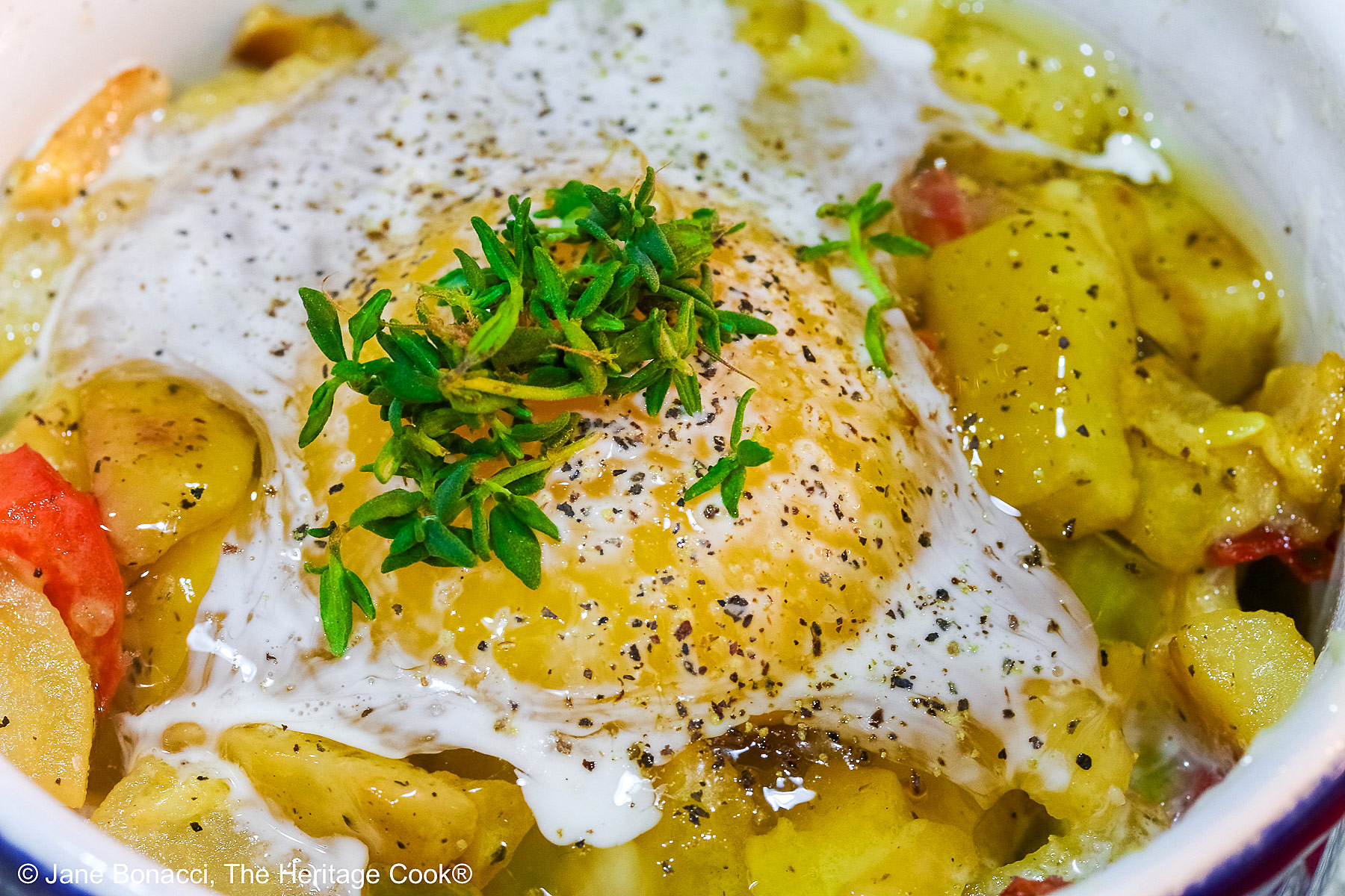 Looking down into the ramekin with the baked egg in a potato nest.
