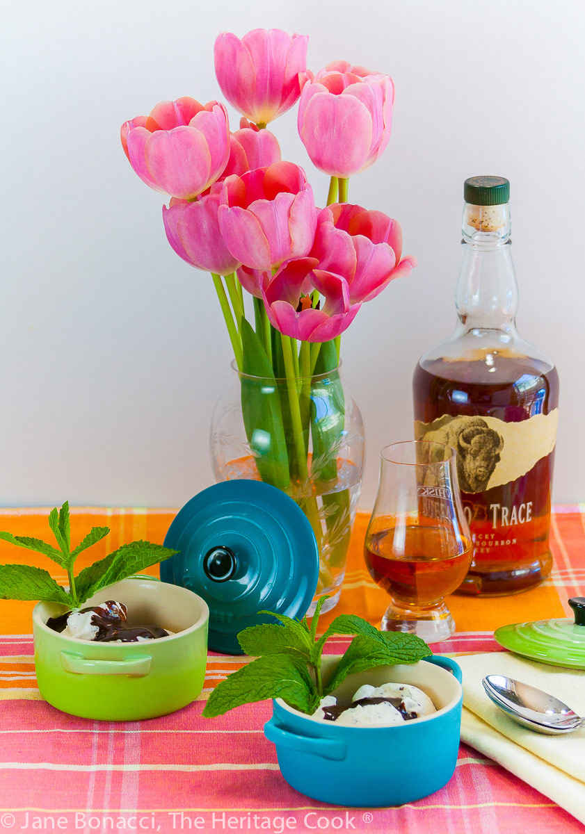 Derby Sundaes with Chocolate Bourbon Sauce, tulips in a vase, glass of bourbon in front of the full bottle