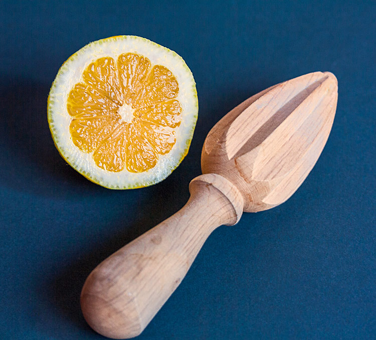 Wooden reamer and sliced lemon 