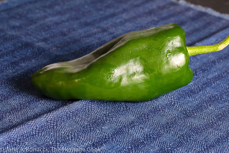 Bright green poblano pepper on blue cloth