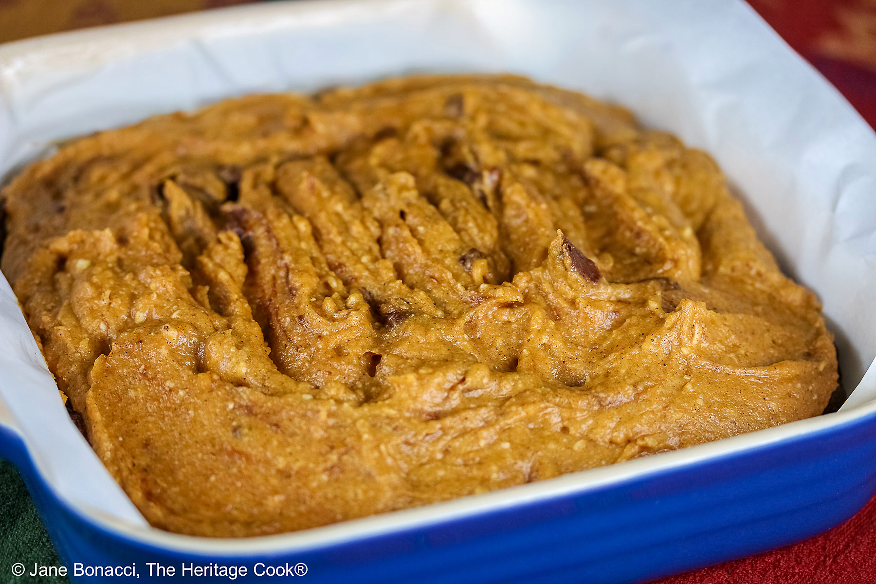 Pumpkin layer over the brownie layer and swirled together, ready for the oven.