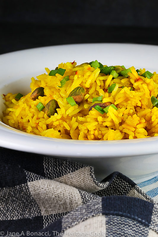 bowl of saffron rice with linens in front, black background; Easy Saffron Rice © 2021 Jane Bonacci, The Heritage Cook