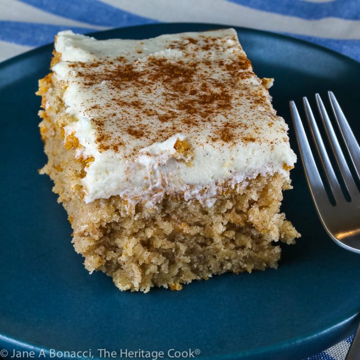 slice of cake on blue plate; Snickerdoodle Cake with White Chocolate Frosting © 2021 Jane Bonacci, The Heritage Cook