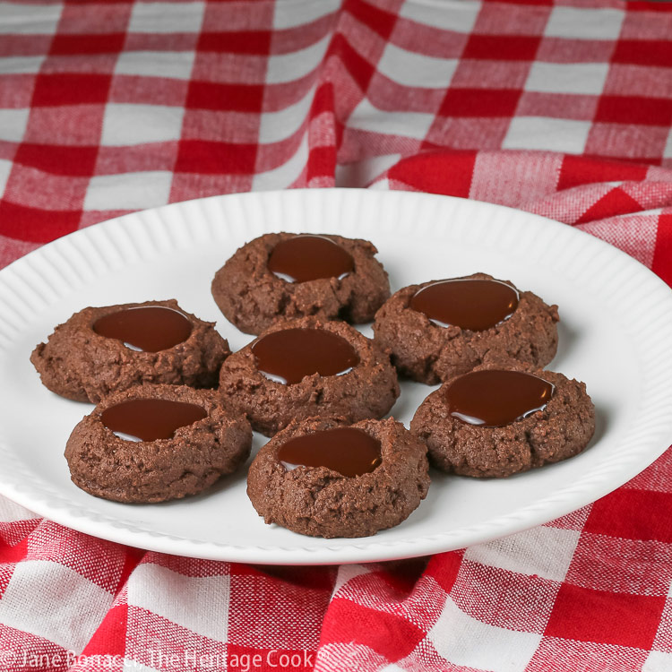 plate of double chocolate thumbprint cookies on red and white checked cloth