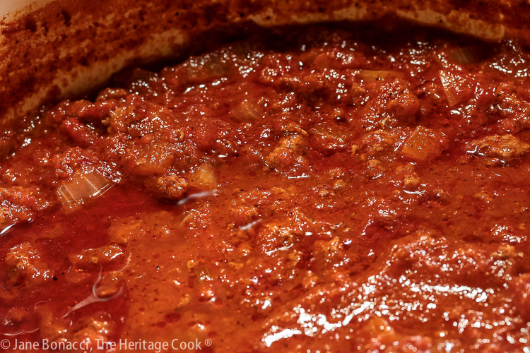 Pot of simmering chili in a large Dutch oven