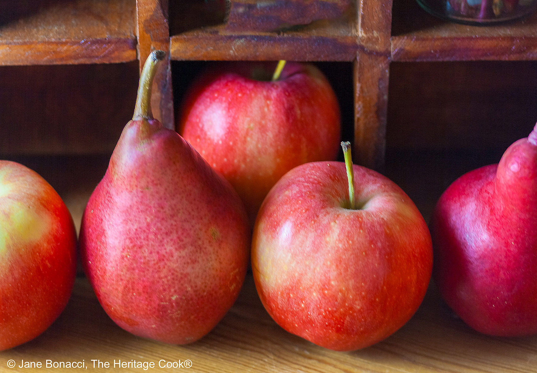 Collection of red pears and apples.